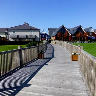 A boardwalk beside modern timber clad buildings on the edge of Kildare town