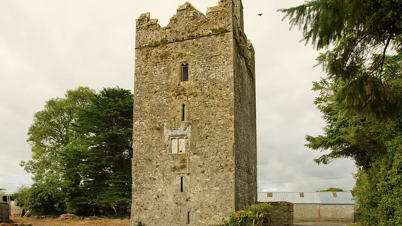 The square tower house of Clara Castle standing among trees