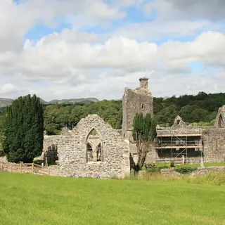 The roofless church and tower of Creevelea Friary in green fields near Dromahair
