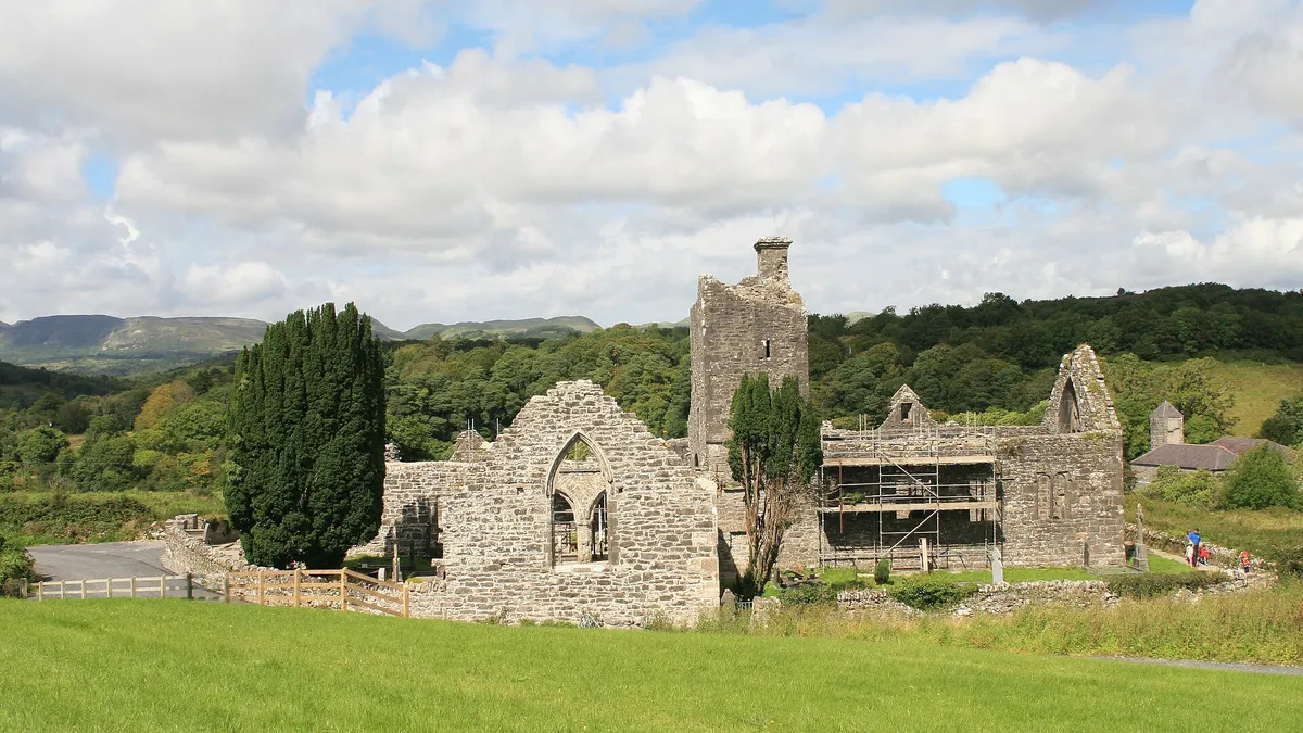 The roofless church and tower of Creevelea Friary in green fields near Dromahair