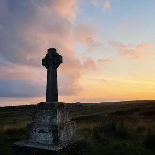A stone high cross against the sunset on Sliabh Beagh, County Monaghan