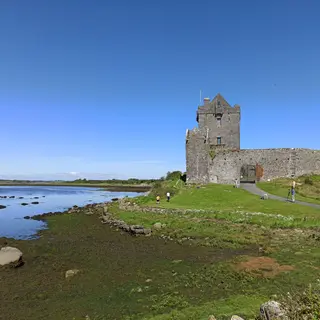 Dunguaire Castle on the edge of Galway Bay under a clear sky