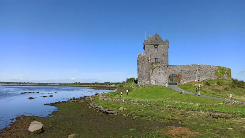 Dunguaire Castle on the edge of Galway Bay under a clear sky