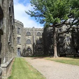 The castellated stone wings of Cork City Gaol seen along its front drive