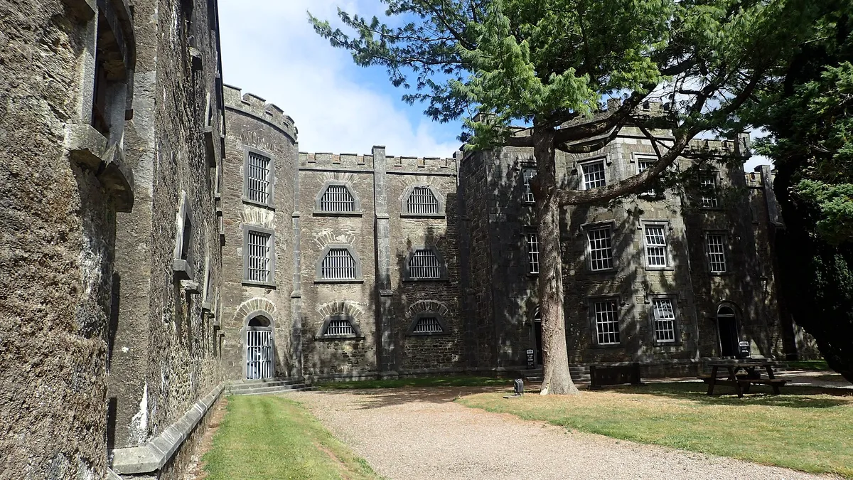 The castellated stone wings of Cork City Gaol seen along its front drive