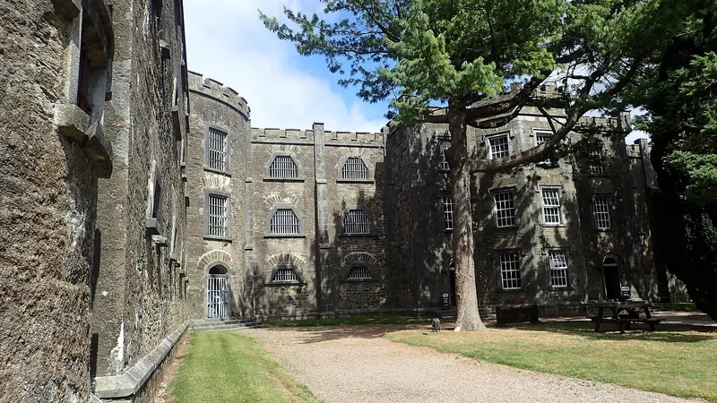 The castellated stone wings of Cork City Gaol seen along its front drive
