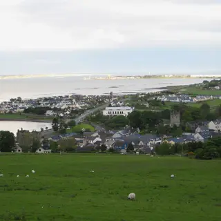 Green fields sloping down to Carlingford town on the lough