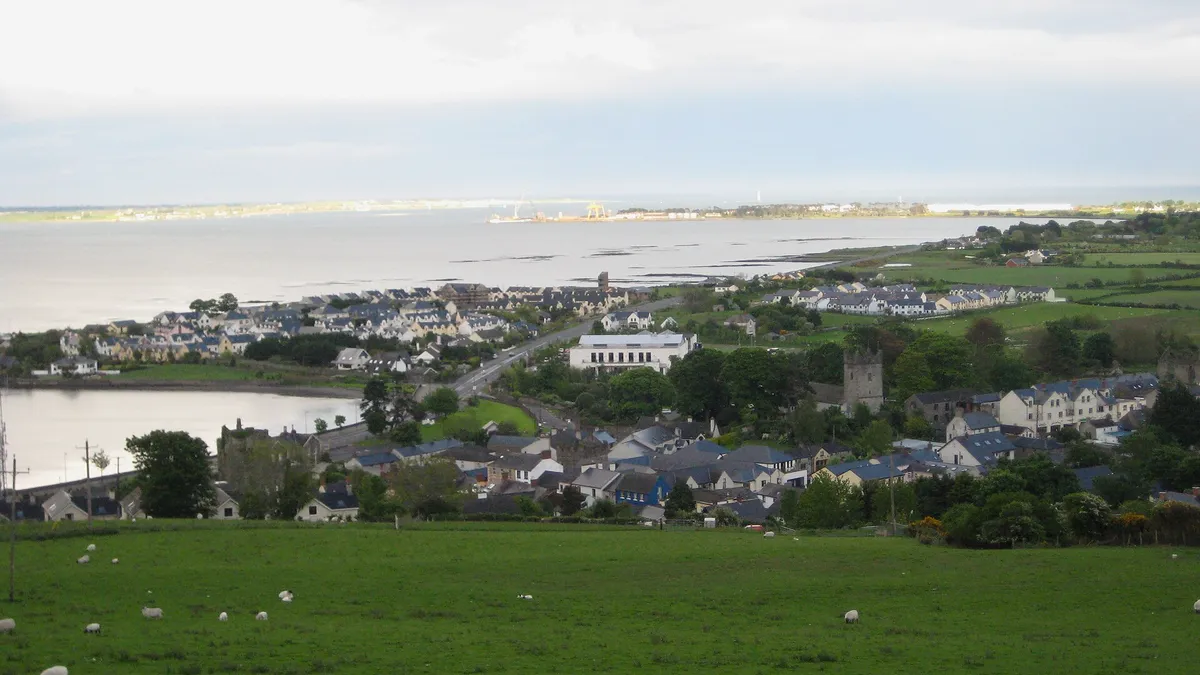 Green fields sloping down to Carlingford town on the lough