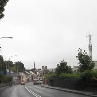 The main street of Glaslough on a grey day with the church spire beyond
