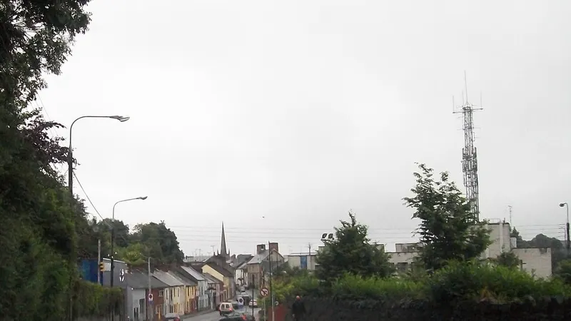 The main street of Glaslough on a grey day with the church spire beyond