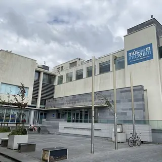 The glass and stone front of Galway City Museum beside the Spanish Arch