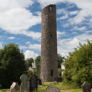 The round tower at Clones standing among the old gravestones