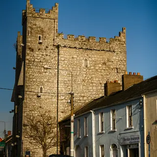 The battlemented tower of Ardee Castle rising above the roofs of the street