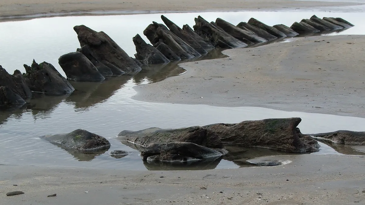 Angled rock ledges running out across the wet sand at Streedagh