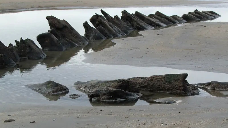 Angled rock ledges running out across the wet sand at Streedagh