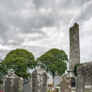 The round tower at Monasterboice standing above the trees