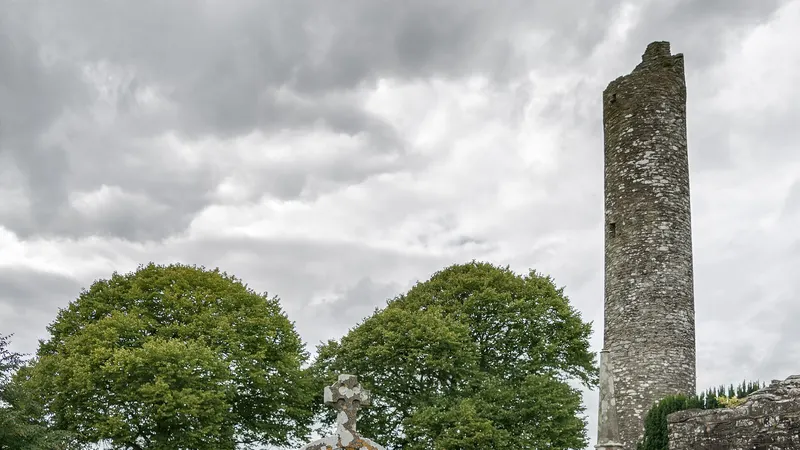 The round tower at Monasterboice standing above the trees