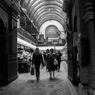 Shoppers walking under the arched roof of the English Market in Cork city