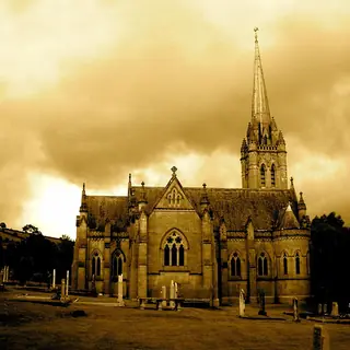 The Adelaide Memorial Church at Myshall silhouetted against a yellow evening sky