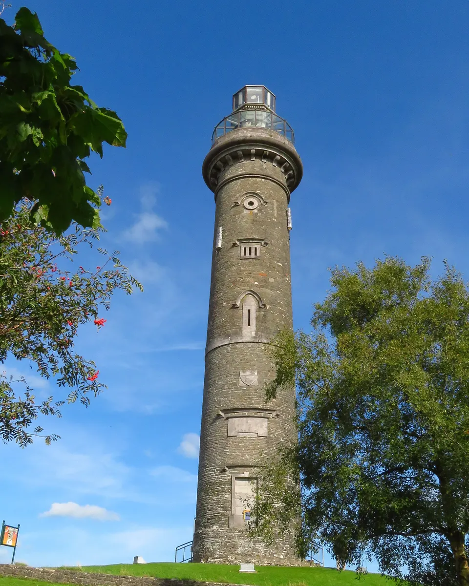 The tall round tower of the Spire of Lloyd at Kells against a blue sky