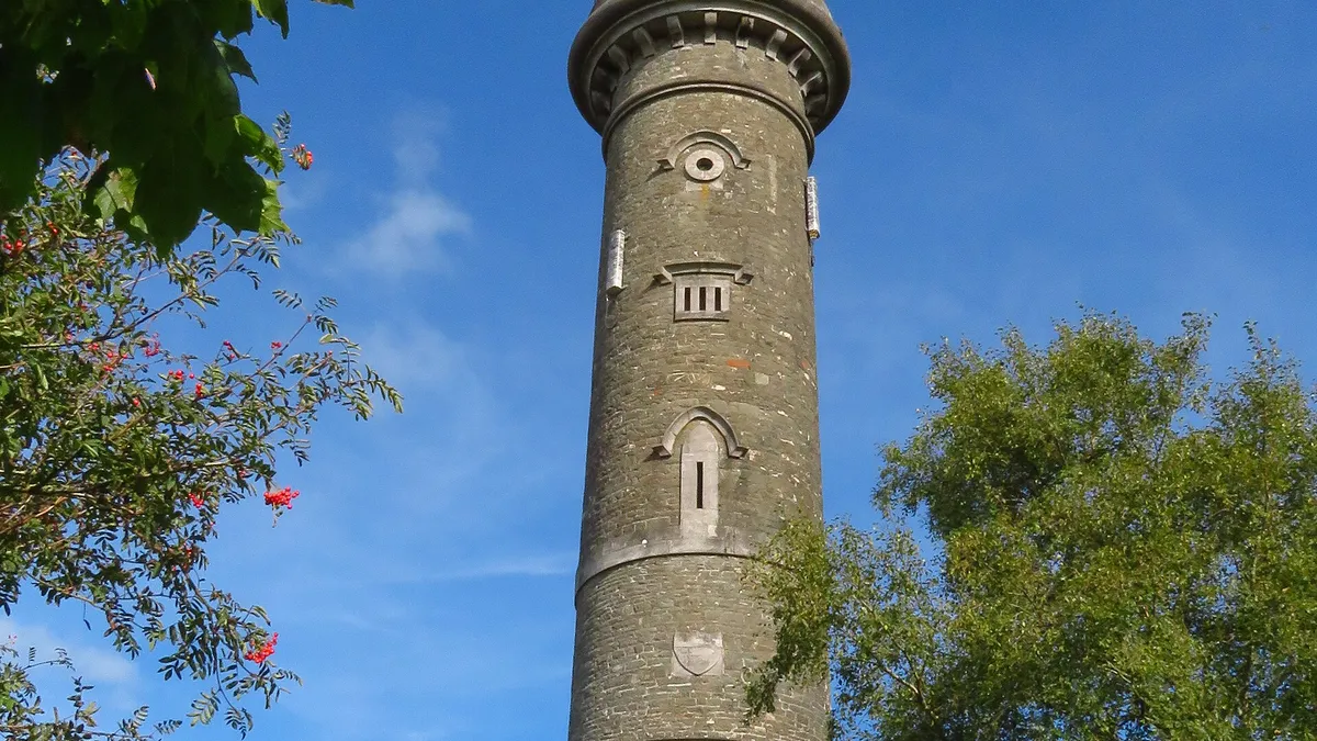 The tall round tower of the Spire of Lloyd at Kells against a blue sky