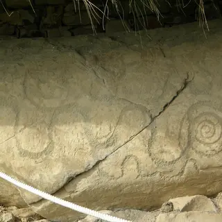 Spirals carved into the edge of a kerbstone at Knowth