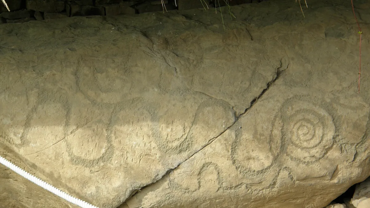 Spirals carved into the edge of a kerbstone at Knowth