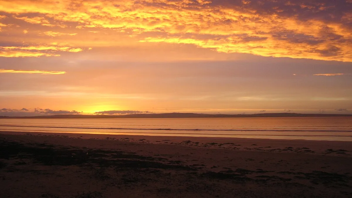 Sunset over the wide sands of Enniscrone Beach, County Sligo