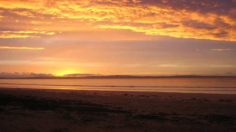 Sunset over the wide sands of Enniscrone Beach, County Sligo