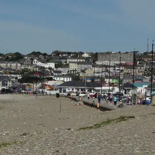 The wide flat strand at Tramore with the town rising behind it