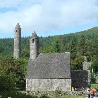 The round tower and church at Glendalough among the trees