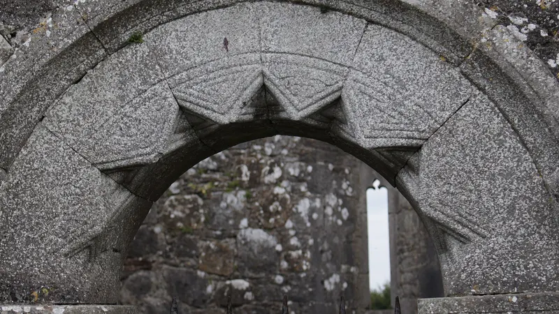 The carved Romanesque chancel arch inside the old church at Rahan