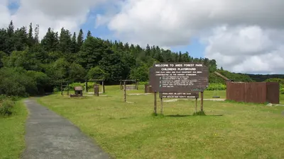 The path and the welcome sign at the entrance to Ards Forest Park