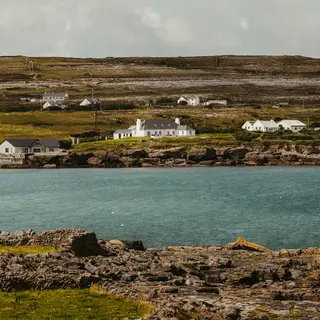 Traditional houses above the rocky shoreline on Inis Mor