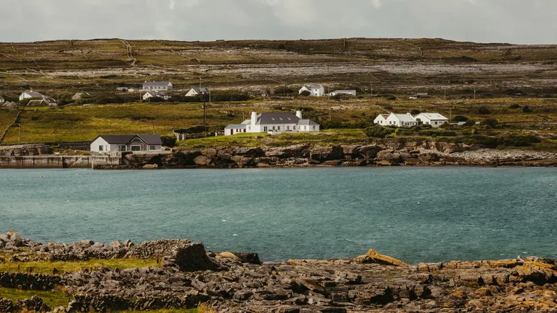Traditional houses above the rocky shoreline on Inis Mor
