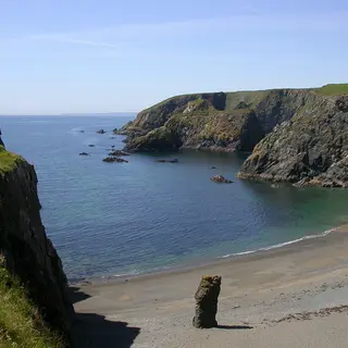Cliffs and a small cove on the Copper Coast with a sea stack below