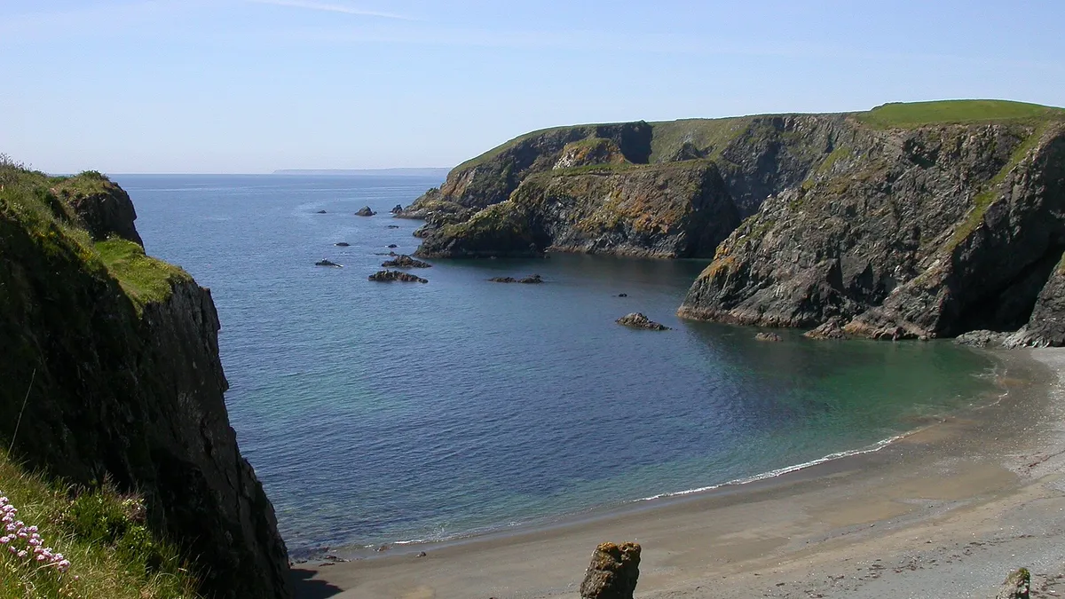 Cliffs and a small cove on the Copper Coast with a sea stack below