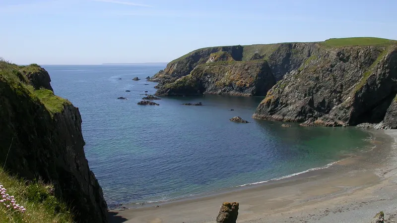 Cliffs and a small cove on the Copper Coast with a sea stack below