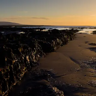 Sunset over the strand and causeway at Coney Island, County Sligo