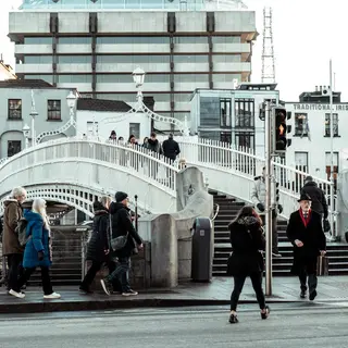 People crossing the Ha'penny Bridge over the Liffey
