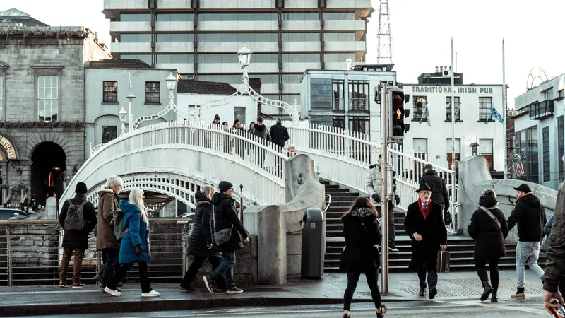 People crossing the Ha'penny Bridge over the Liffey