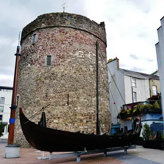 Reginald's Tower on the quay in Waterford with a Viking longboat replica beside it