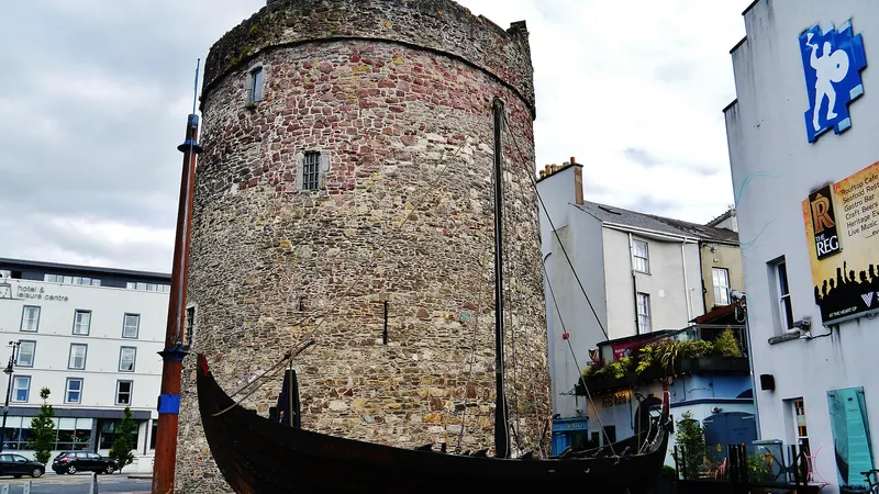 Reginald's Tower on the quay in Waterford with a Viking longboat replica beside it