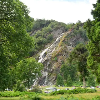 Powerscourt Waterfall falling down the wooded rock face
