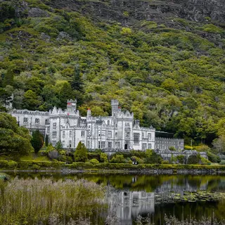 Kylemore Abbey and its reflection in the lake below the mountain