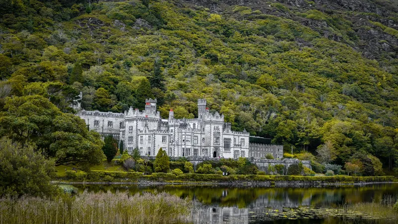 Kylemore Abbey and its reflection in the lake below the mountain