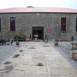 The stone courtyard behind Lissadell House with tables set out on the flags