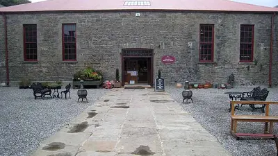 The stone courtyard behind Lissadell House with tables set out on the flags