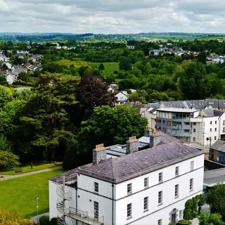 Kilkenny rooftops and trees looking out over the countryside from St Canice's round tower