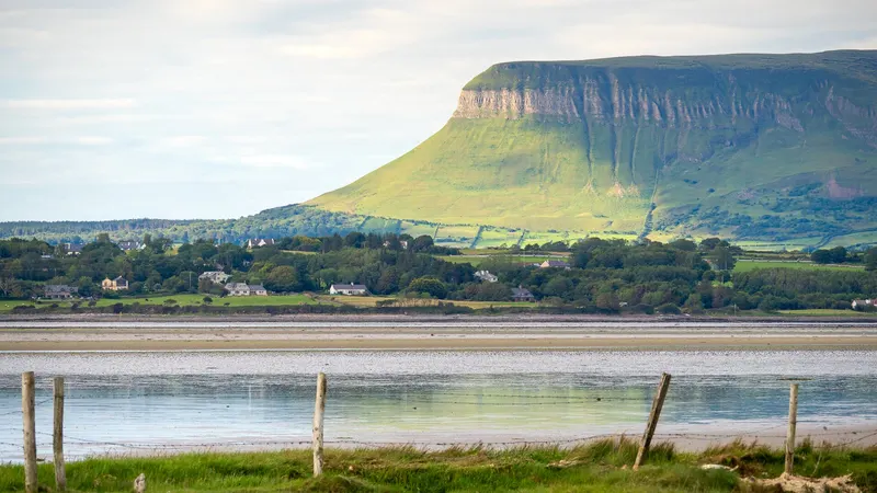 The flat top and steep face of Benbulben above the fields and the estuary